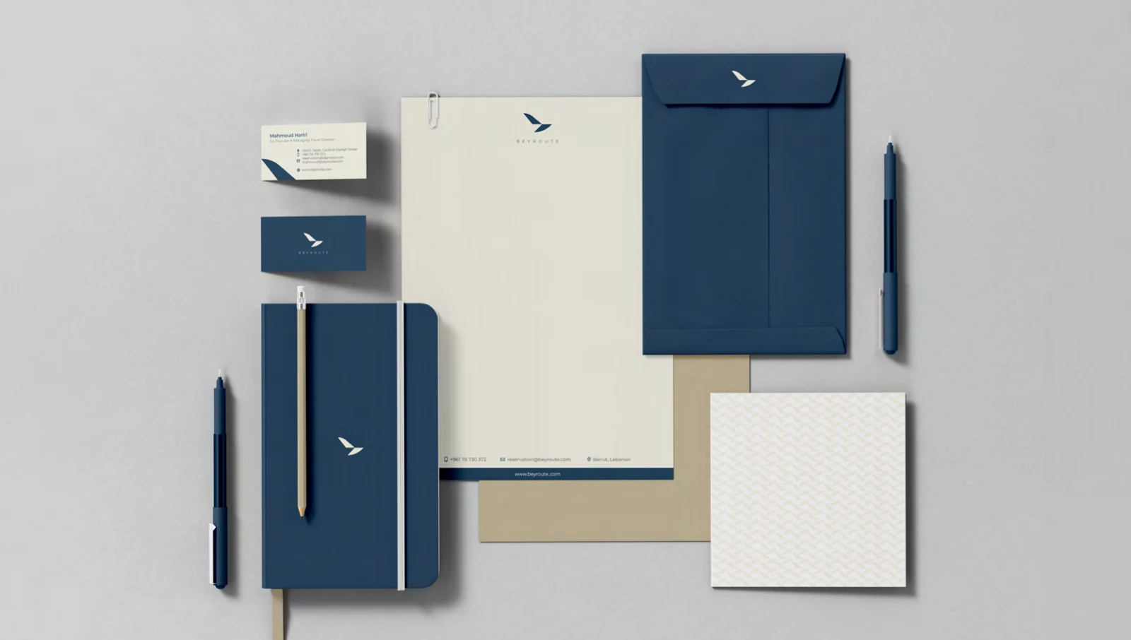 Coordinated Beyroute stationery with navy folders, envelopes, business cards, notebook and pen